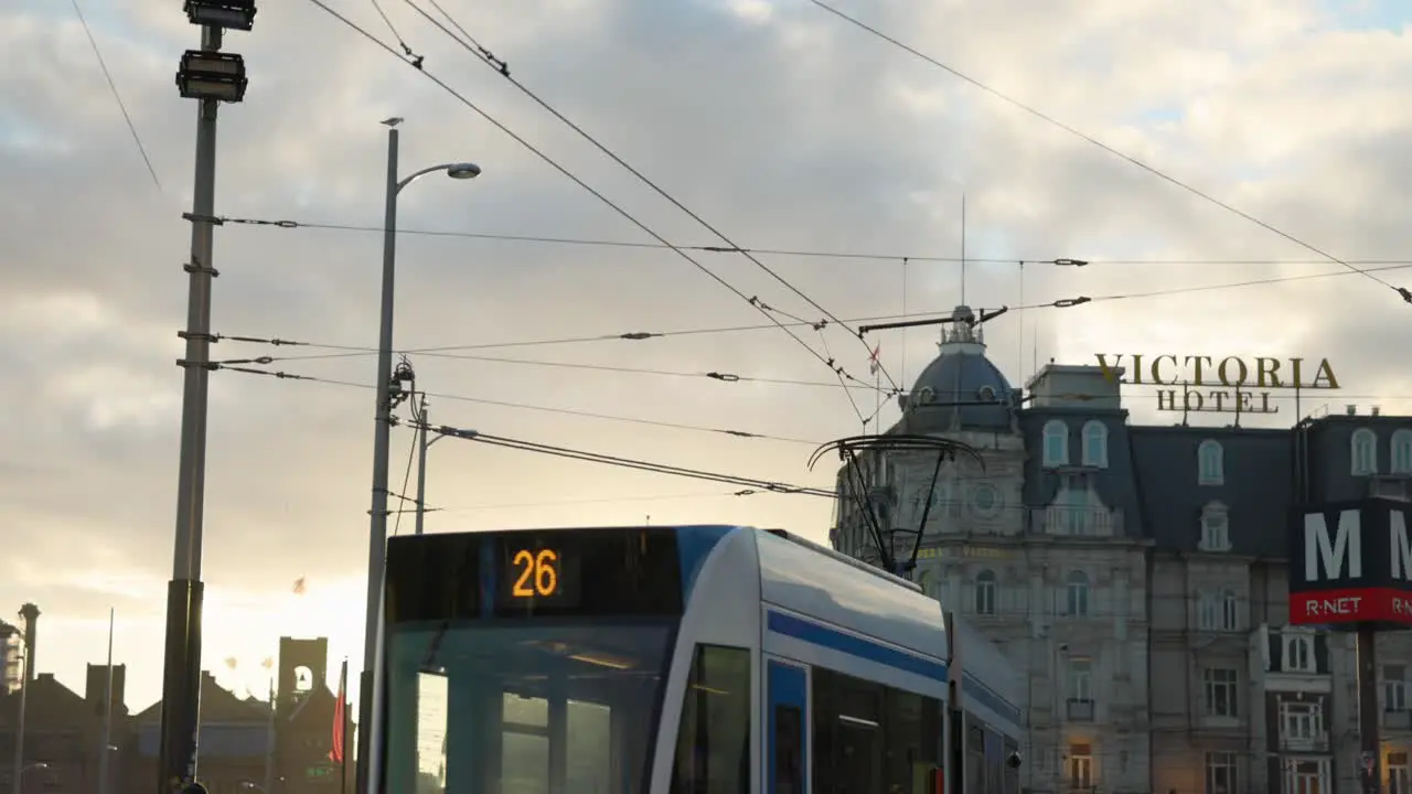 Slow motion busy street scene in Amsterdam with tram pedestrians at dusk