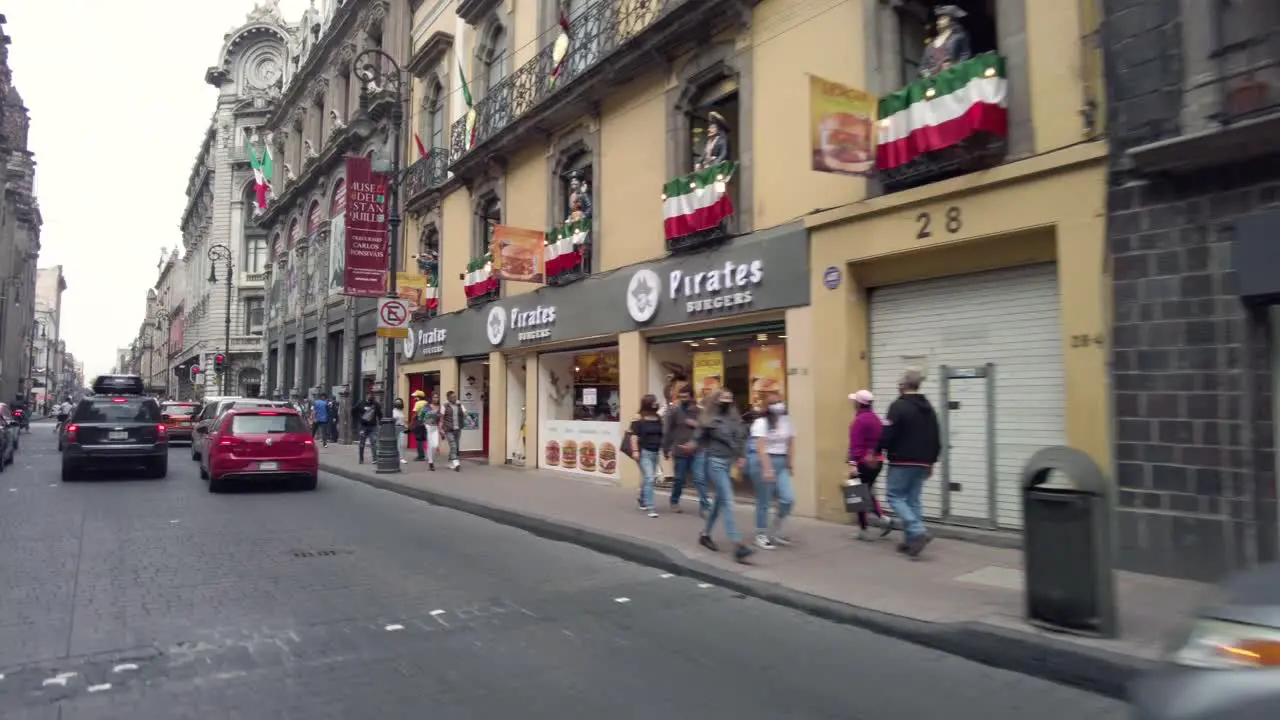 People walking at downtown Mexico city streets shot from a car perspective