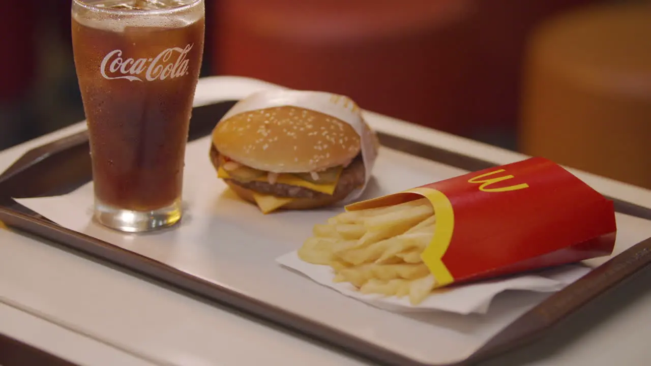 Slow Motion Tilt Up Shot Of Coke Mcdonald's Burger And Fries