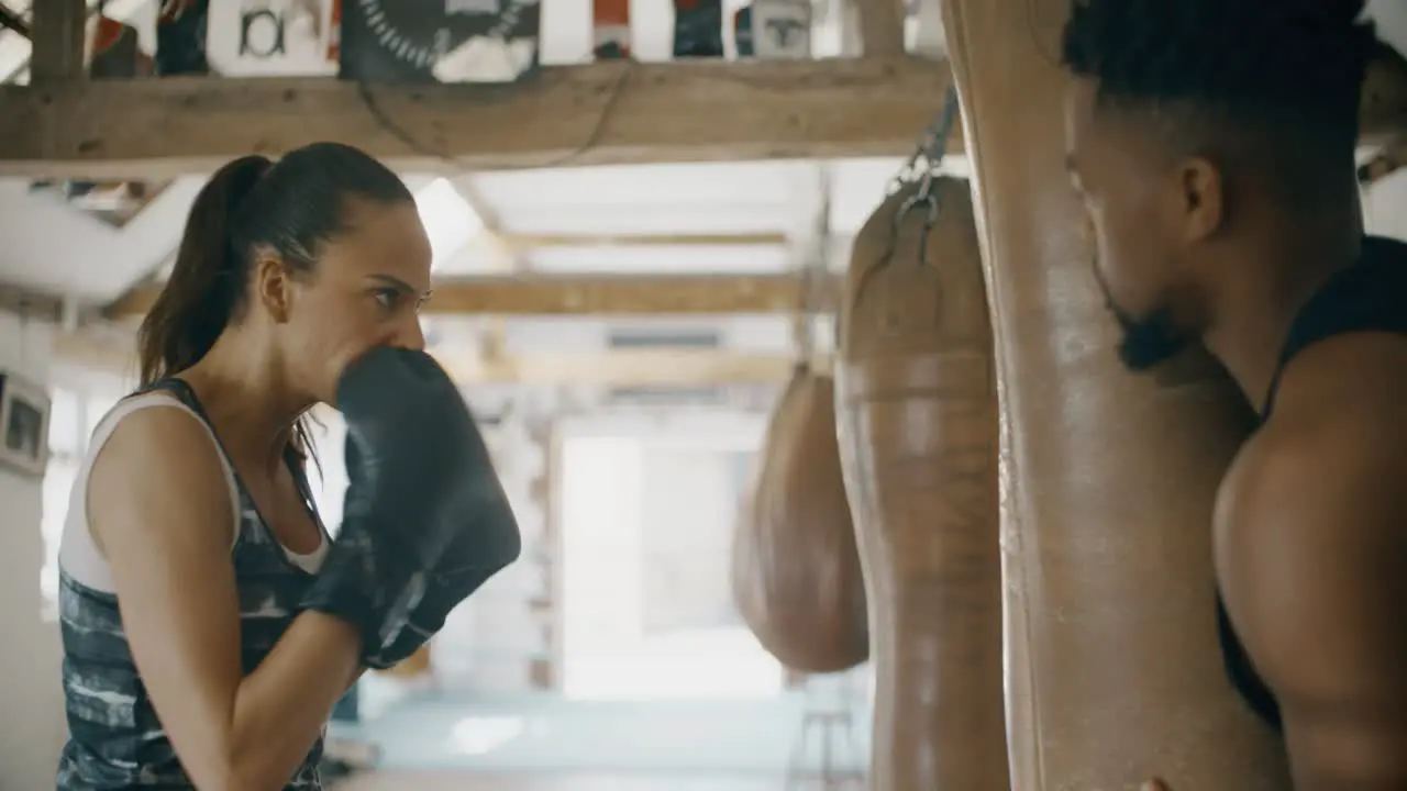 Woman and Man Training in Boxing Gym