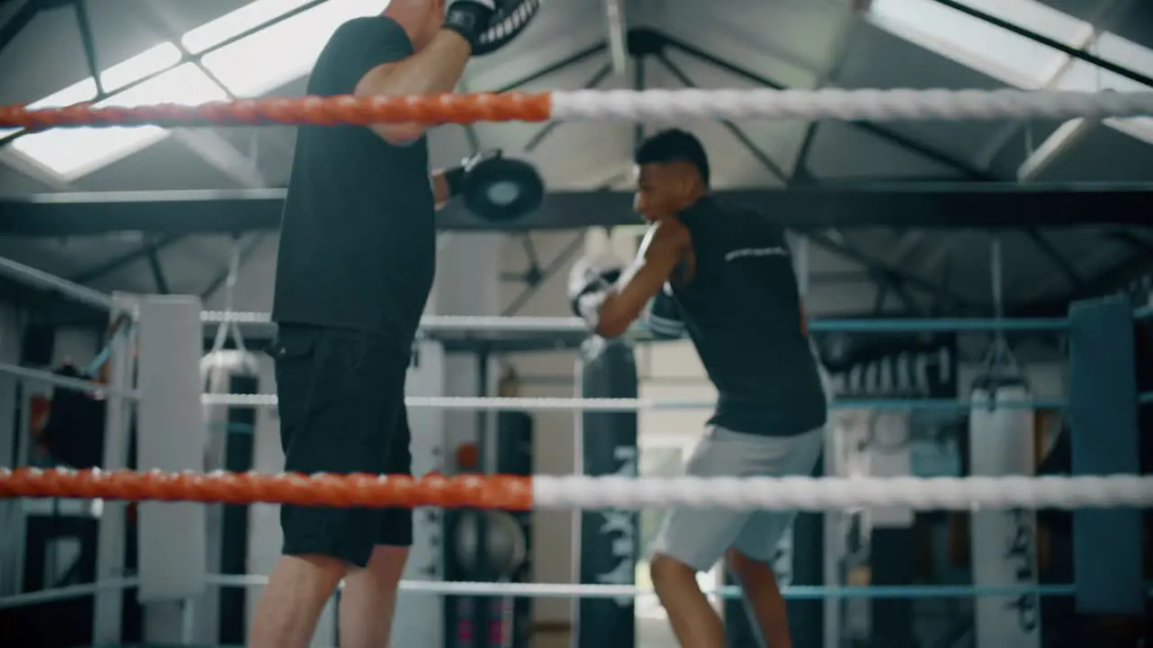 Young Boxer Training with Coach 2