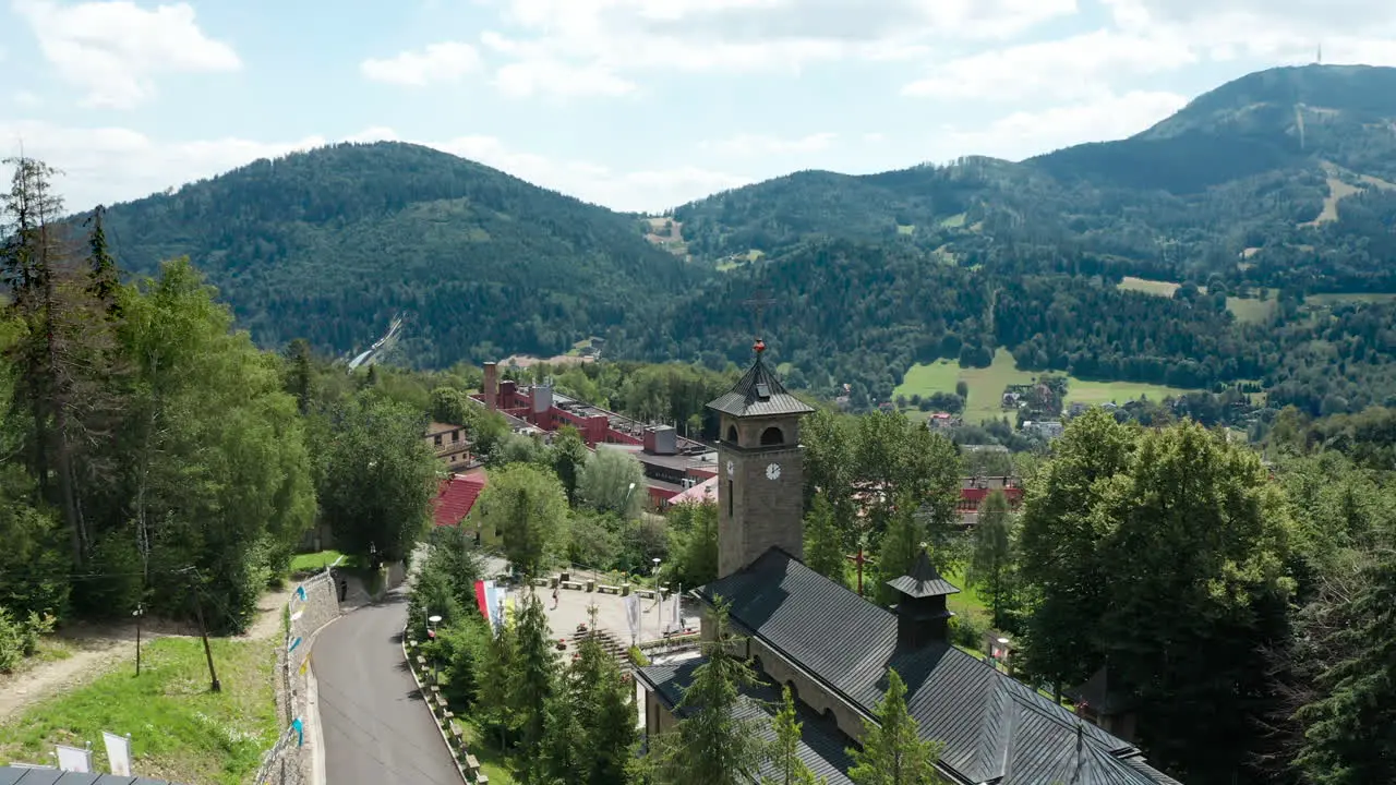 Aerial drone view of Sanctuary of Mother of God Polish Queen and Beskid mountains in the background