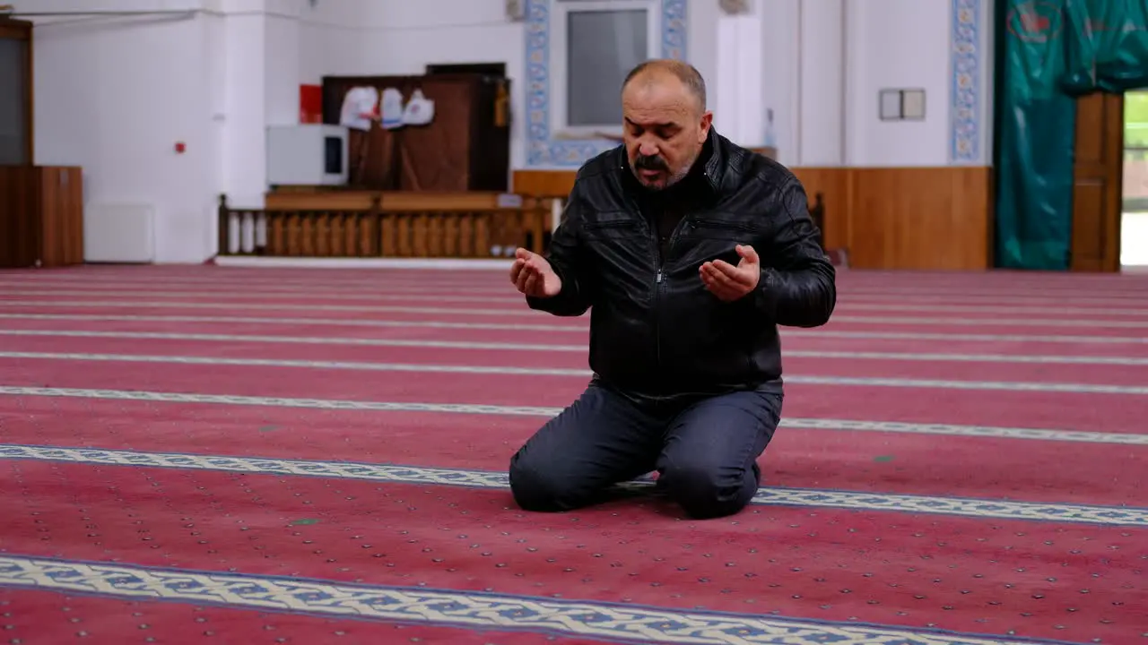 Old Man Wearing Mask Raising His Hands And Praying In The Mosque