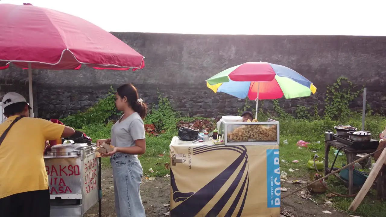 Street Food Sellers in Bali Beach Bakso and Fried Snacks Indonesia Local Market Traditional Umbrellas and People Buying in Sukawati Purnama Gianyar