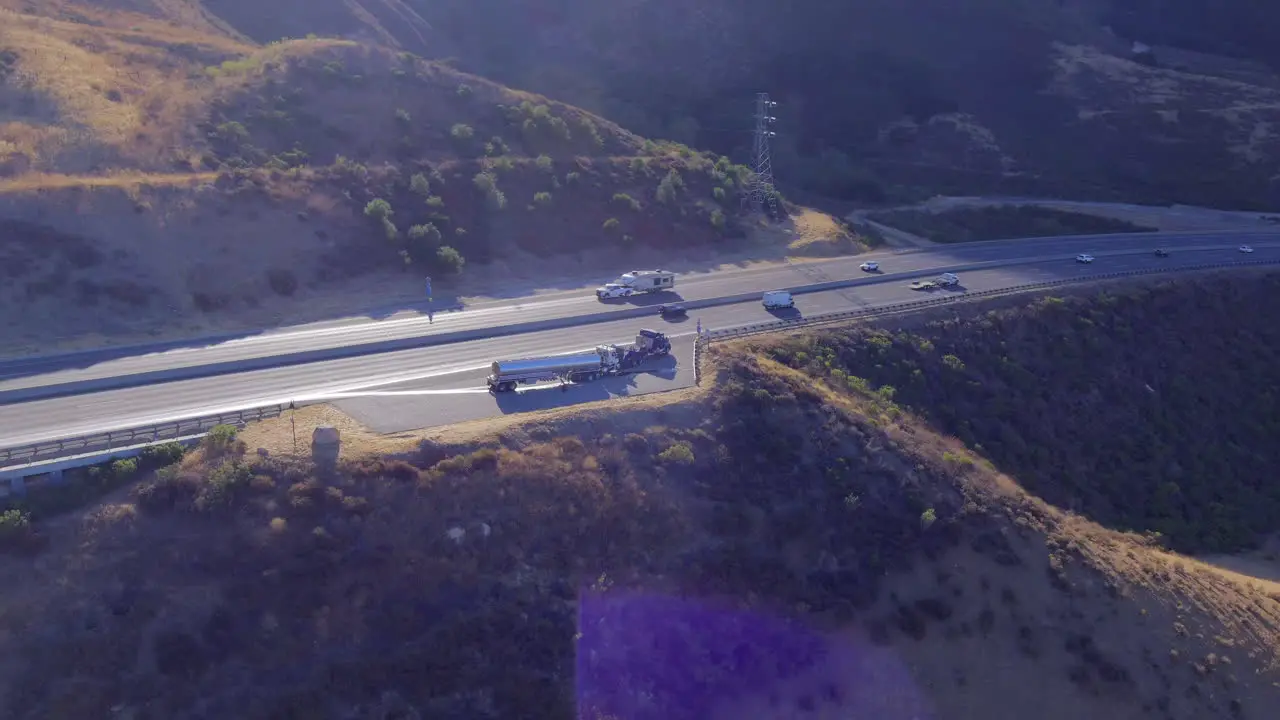 Aerial orbit view of truck roadside assistance next to busy highway