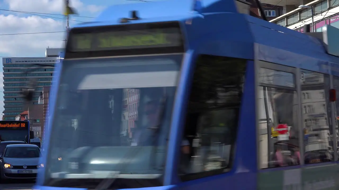 Establishing shot of a business district in Munich Germany with tram passing