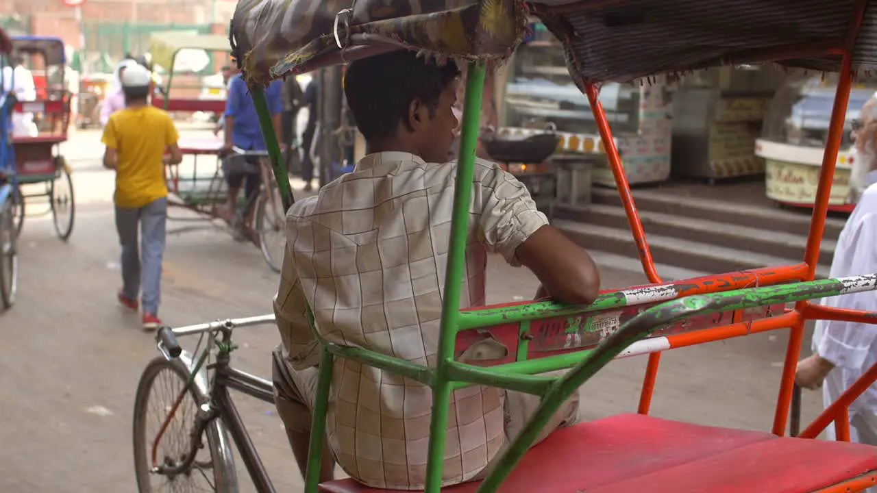 Handheld Shot of a Driver Sitting in a Rickshaw