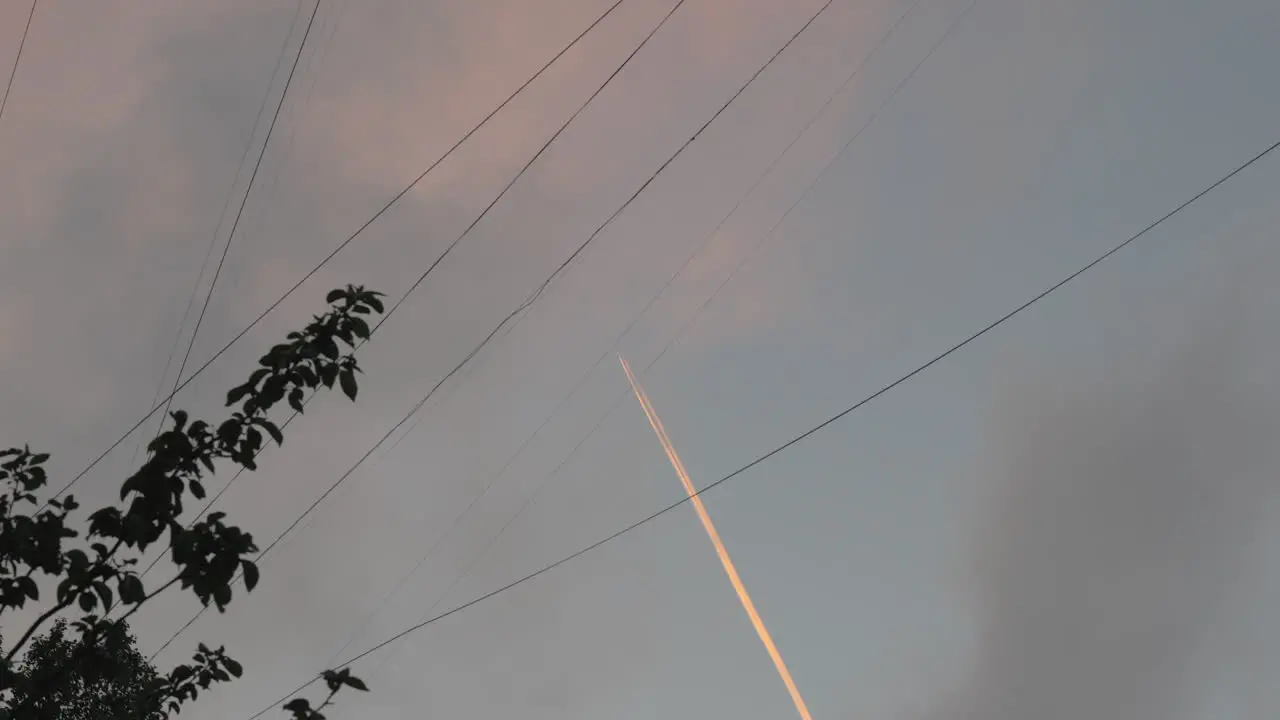 Plane with white trail in the sky