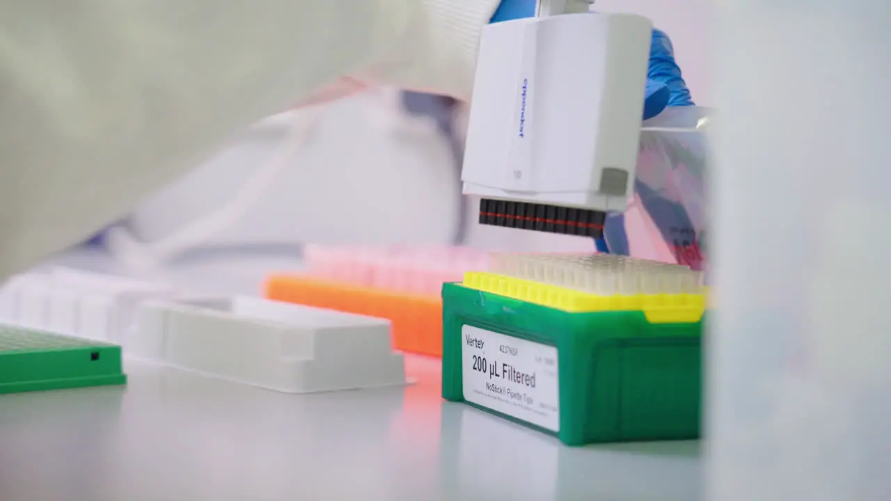 Close Up Of Scientist In Blue Gloves Reloading Tips Onto Multichannel Pipette In Research Laboratory 4K