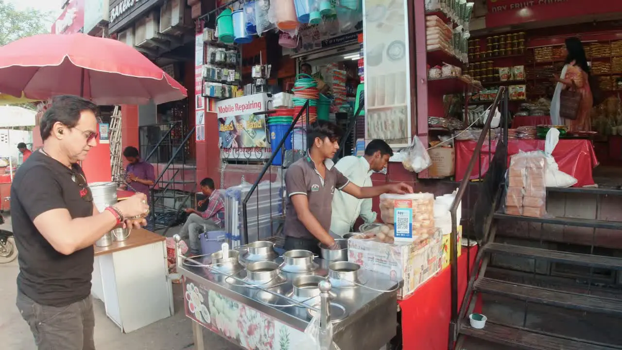 Tourist Buying and Trying Indian Delicacies From a Street Food Vendor in India