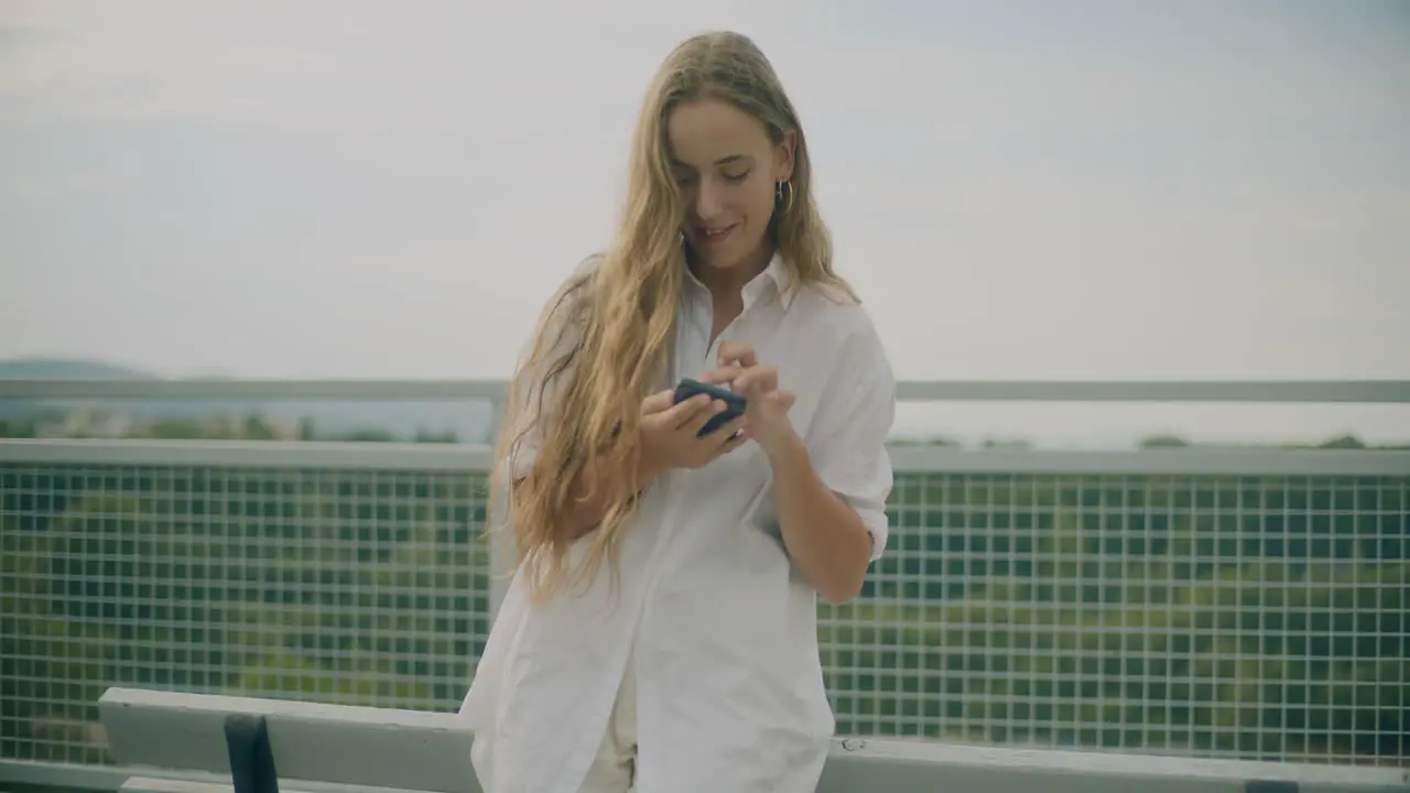 Woman Browsing Smartphone Outdoors