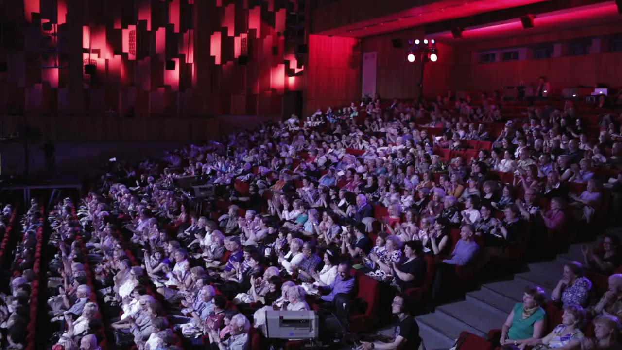 People applaud in the theater