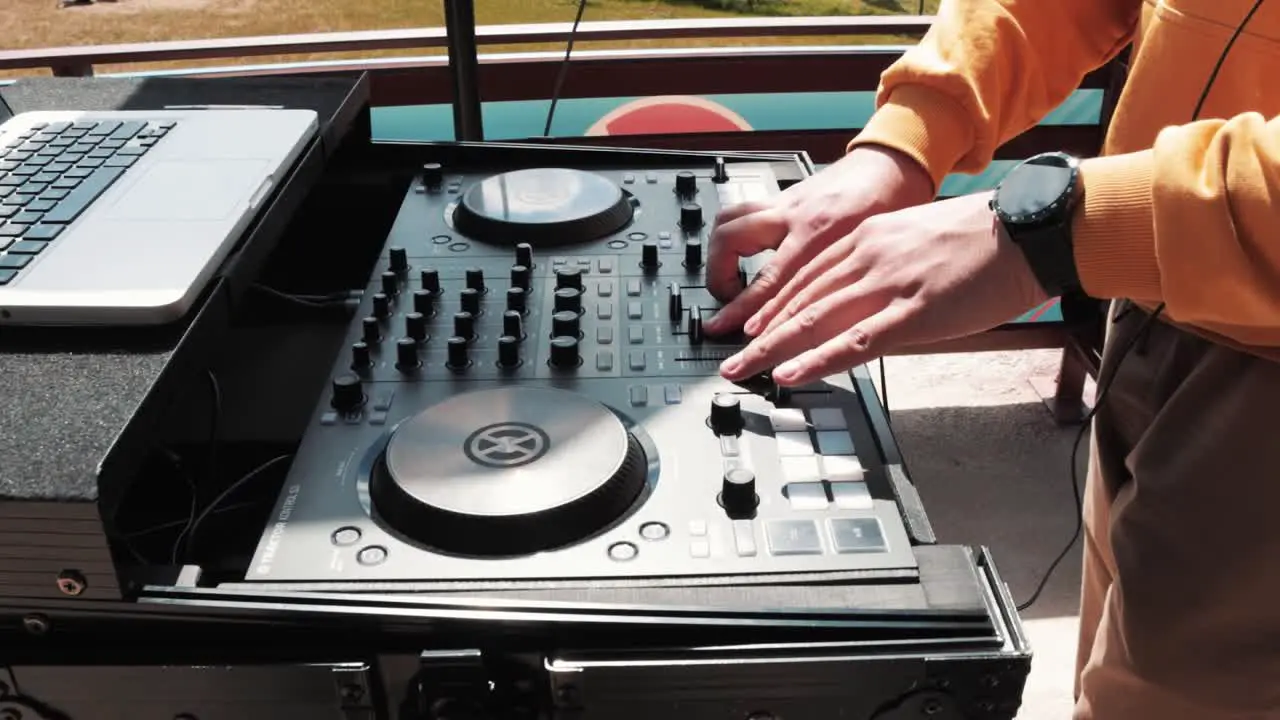 Fashionable DJ playing electronic music at a modern party