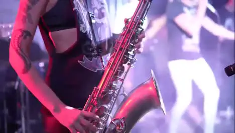 Unrecognizable musician is playing on saxophone in concert Close-up on fingers pressing the keys of the instrument Slow Motion