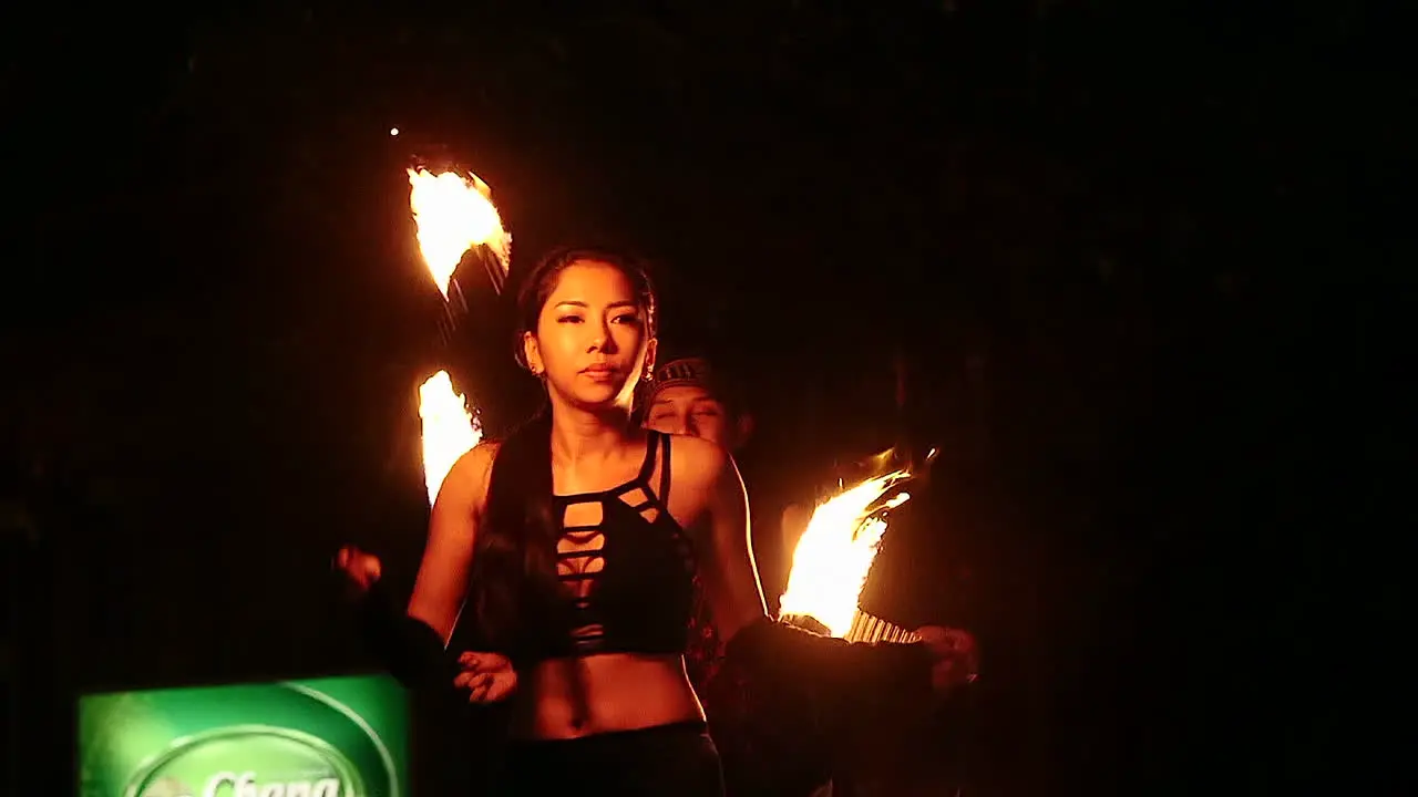 Youung lady performing fire show at night safari Singapore