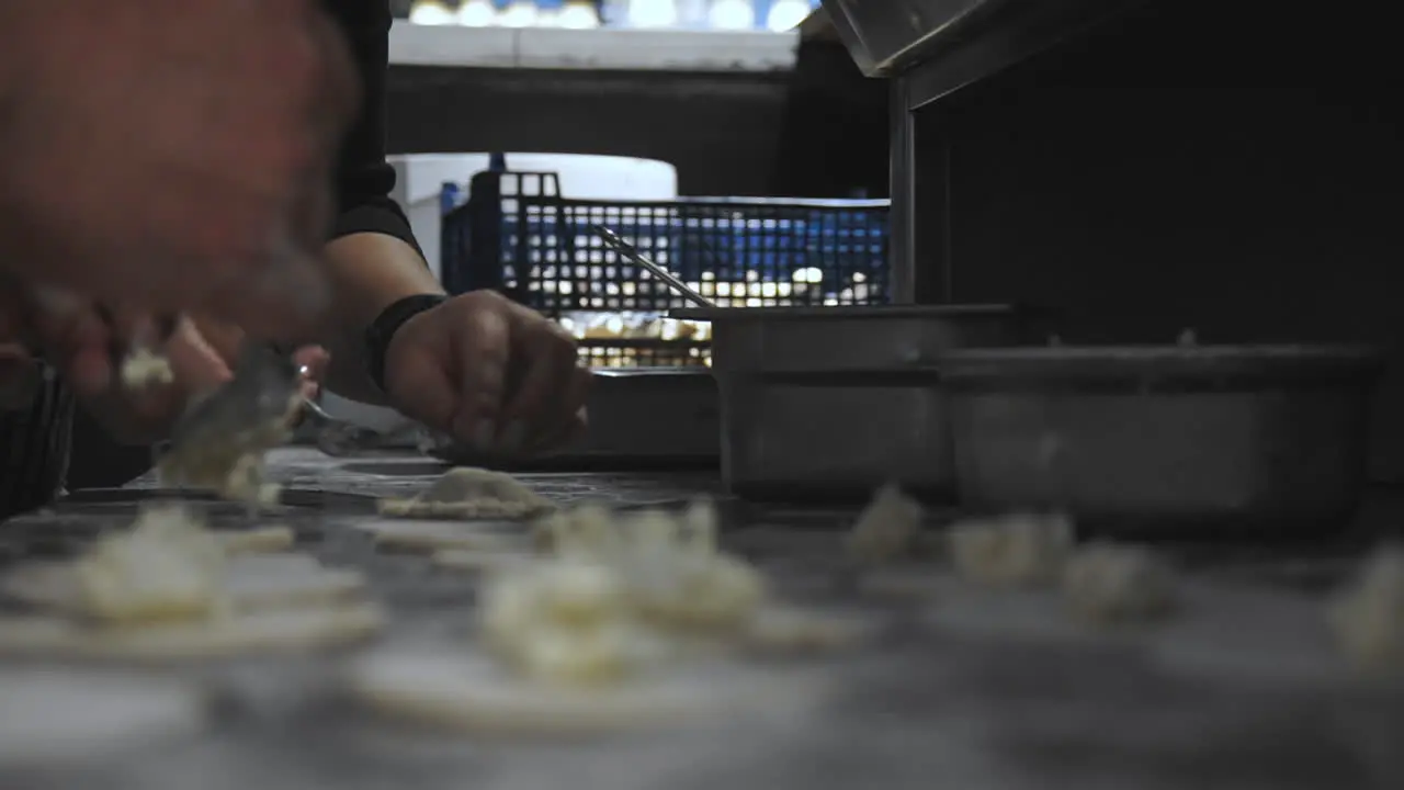 CLOSEUP footage of cooks preparing panzerotti at italian restaurant