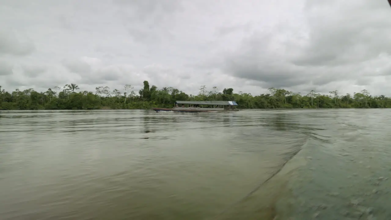 Amazonian river passenger boat speeds by