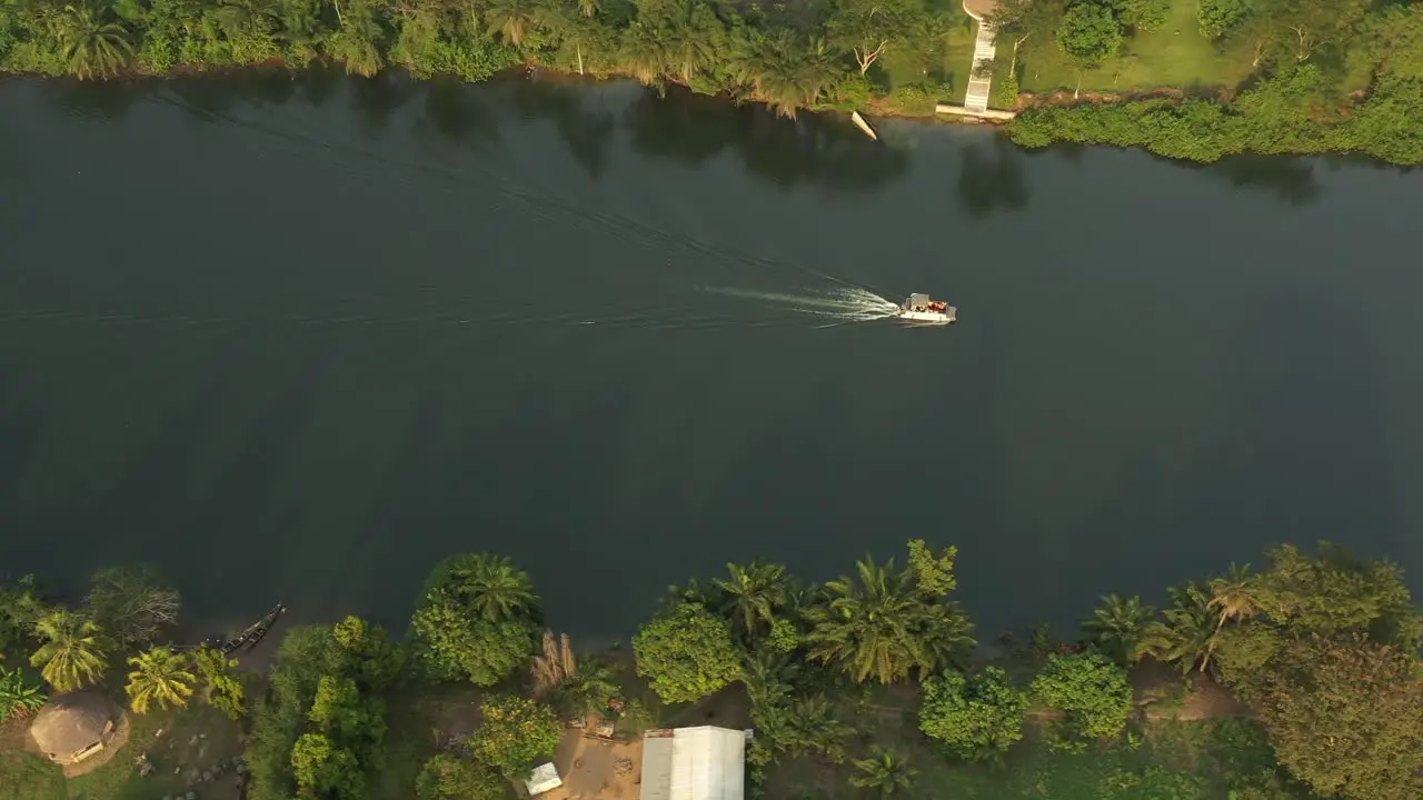 cruise boat with people on river with greens