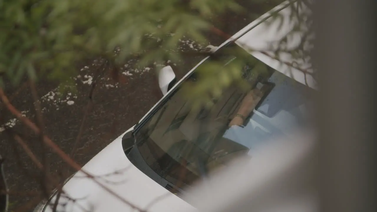 A person in a car in the rain