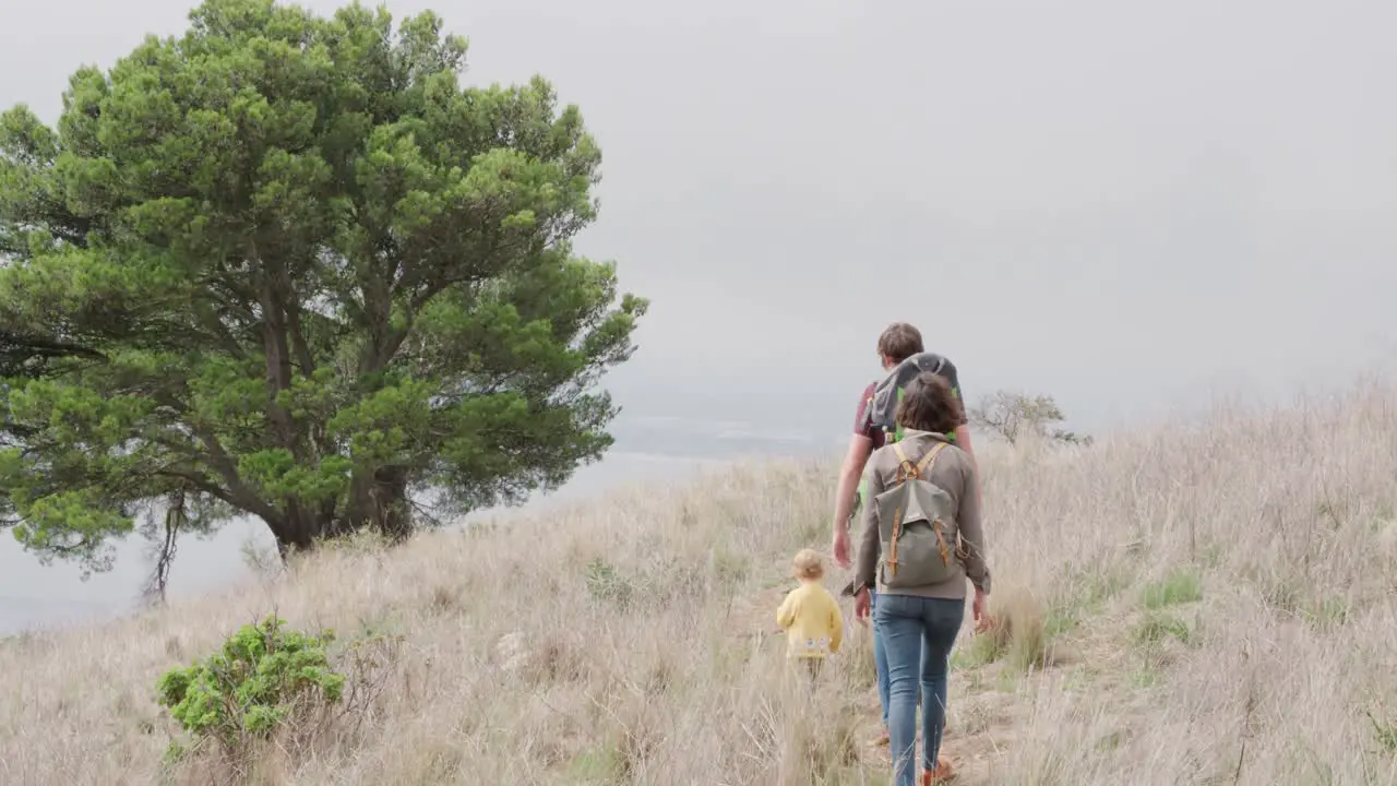 Caucasian family walking in forest