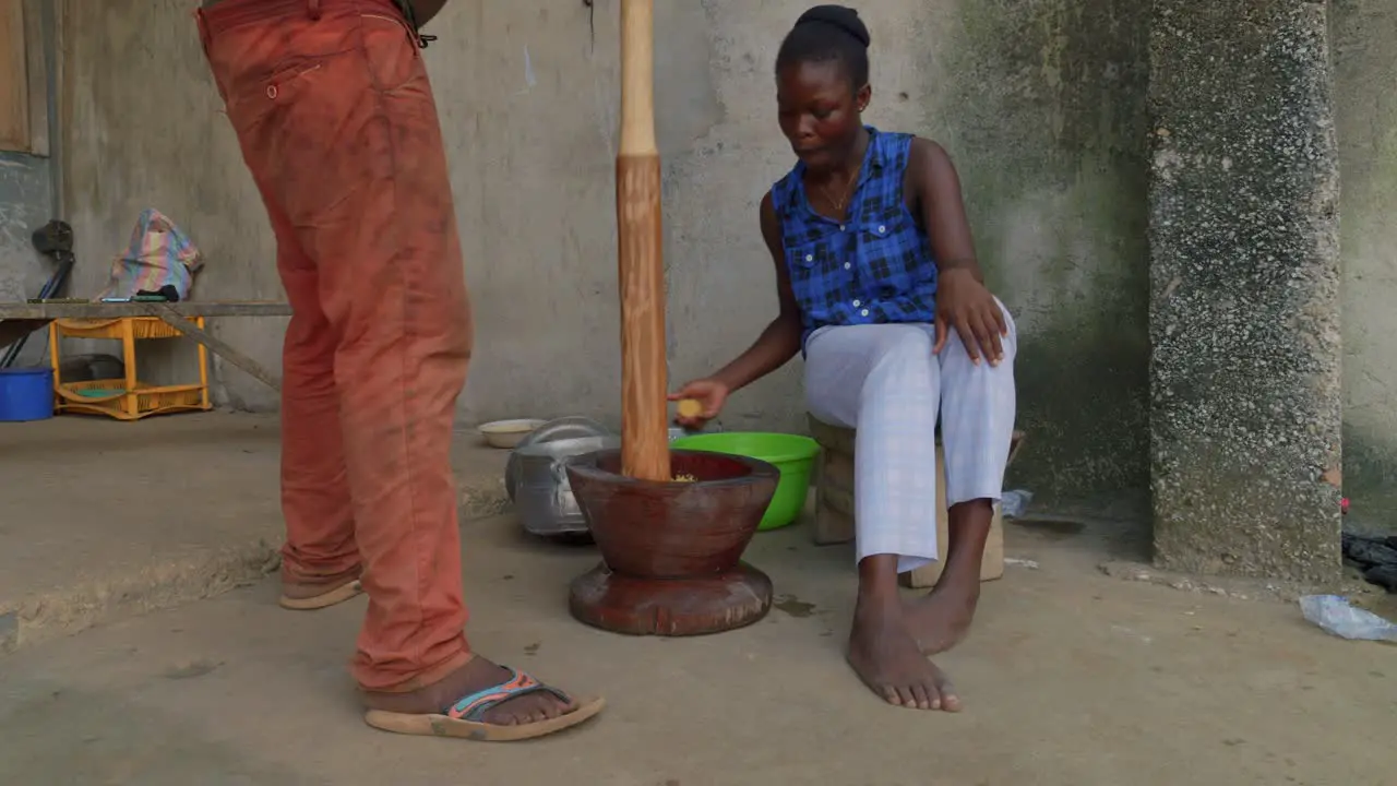 couple preparing traditional food recipe in Ghana rural remote village