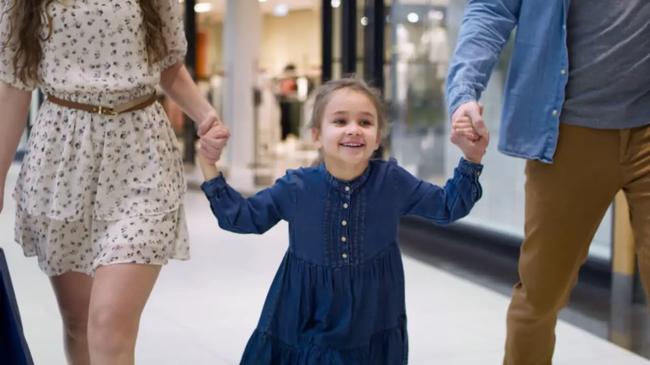 Video of happy little girl during shopping at the mall