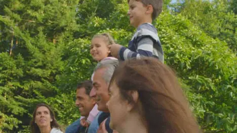 Tracking Shot of Children Riding On Their Family's Shoulders 02