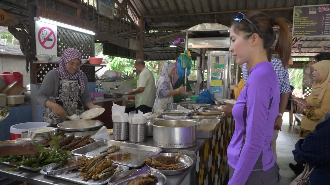 Atheltic woman orders food from restaurant in Sungai Pentani Kedah Malaysia