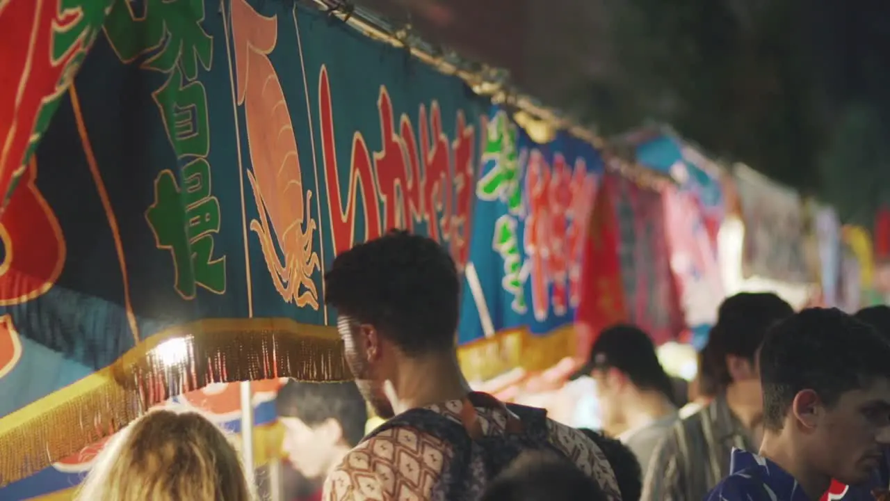 Tourists Choosing Which Street Food To Buy From Yatai Food Vendors During Yoiyama Festival At The Gion Matsuri Festival Night In Kyoto Japan close up