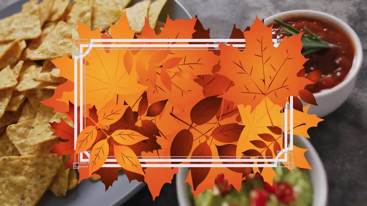 Animation of frame with fall leaves over nachos with dips