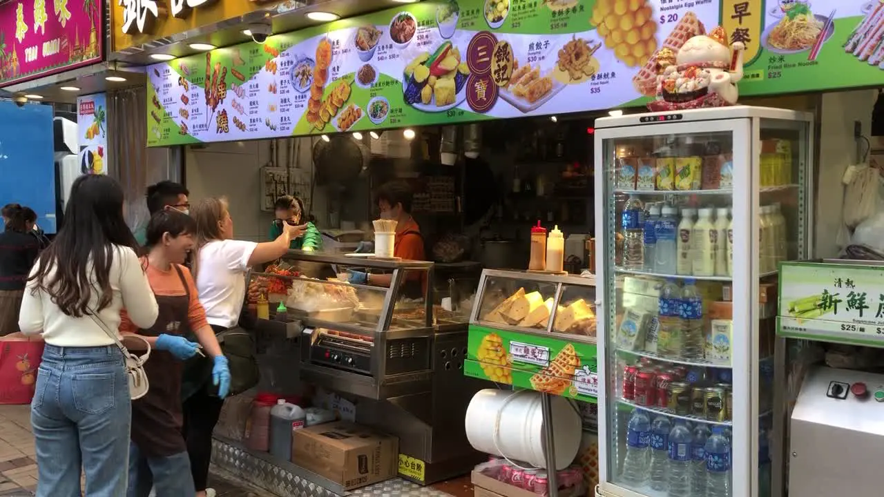 People buy food from a food shop in iSQUARE near Harbour City in central Hong Kong