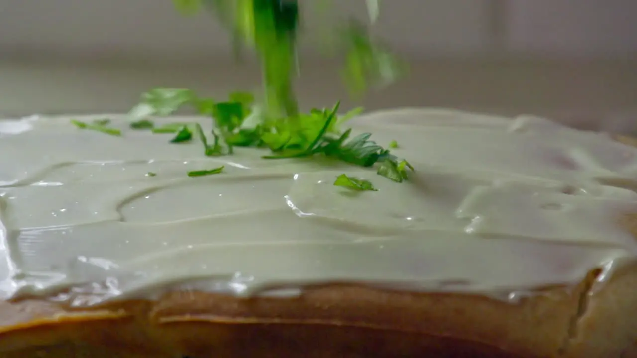 A shot of sparkling parsley over a sandwich