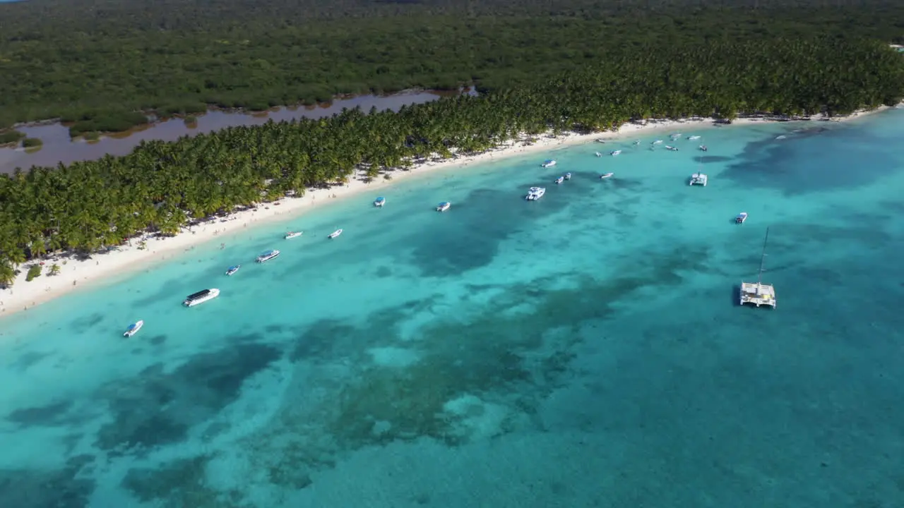 Catamarans and yachts anchoring offshore tropical Isla Saona coast