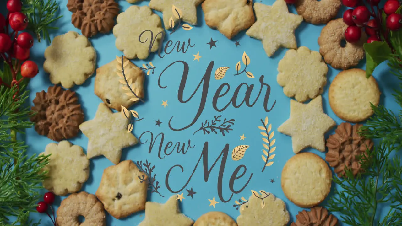 Animation of new year new me text over christmas cookies on blue background