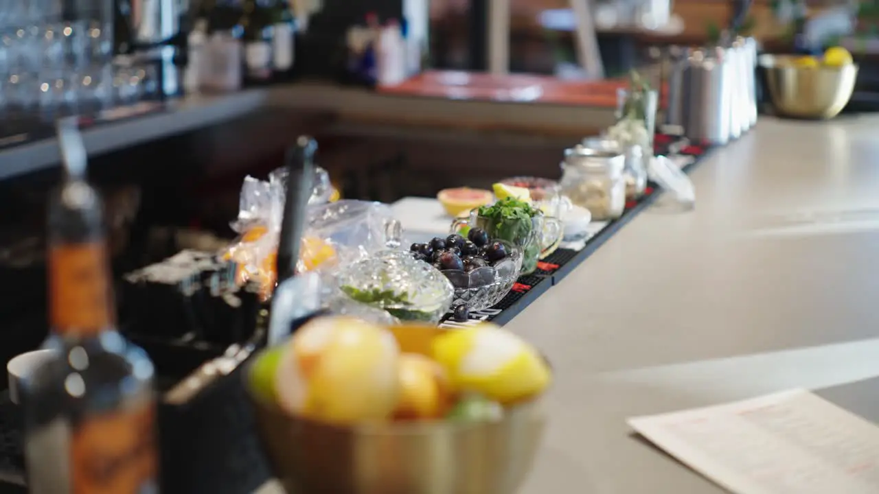 Bowl of lemons camera tilting up to showcase fruits and vegetables in a bar