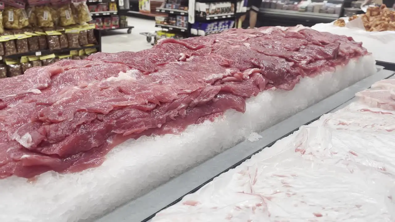 fresh red meat in ice fridge in local supermarket