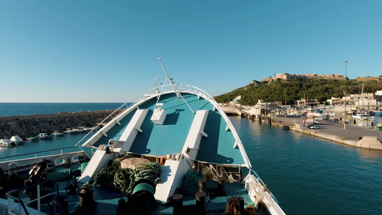 A vehicular ferry arriving at Gozo Island with the bow opening up to let the cars depart