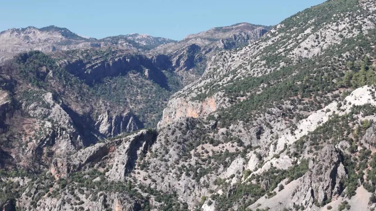 Exposed white grey rocks dotted with low shrubs in Taurus mountains Turkey