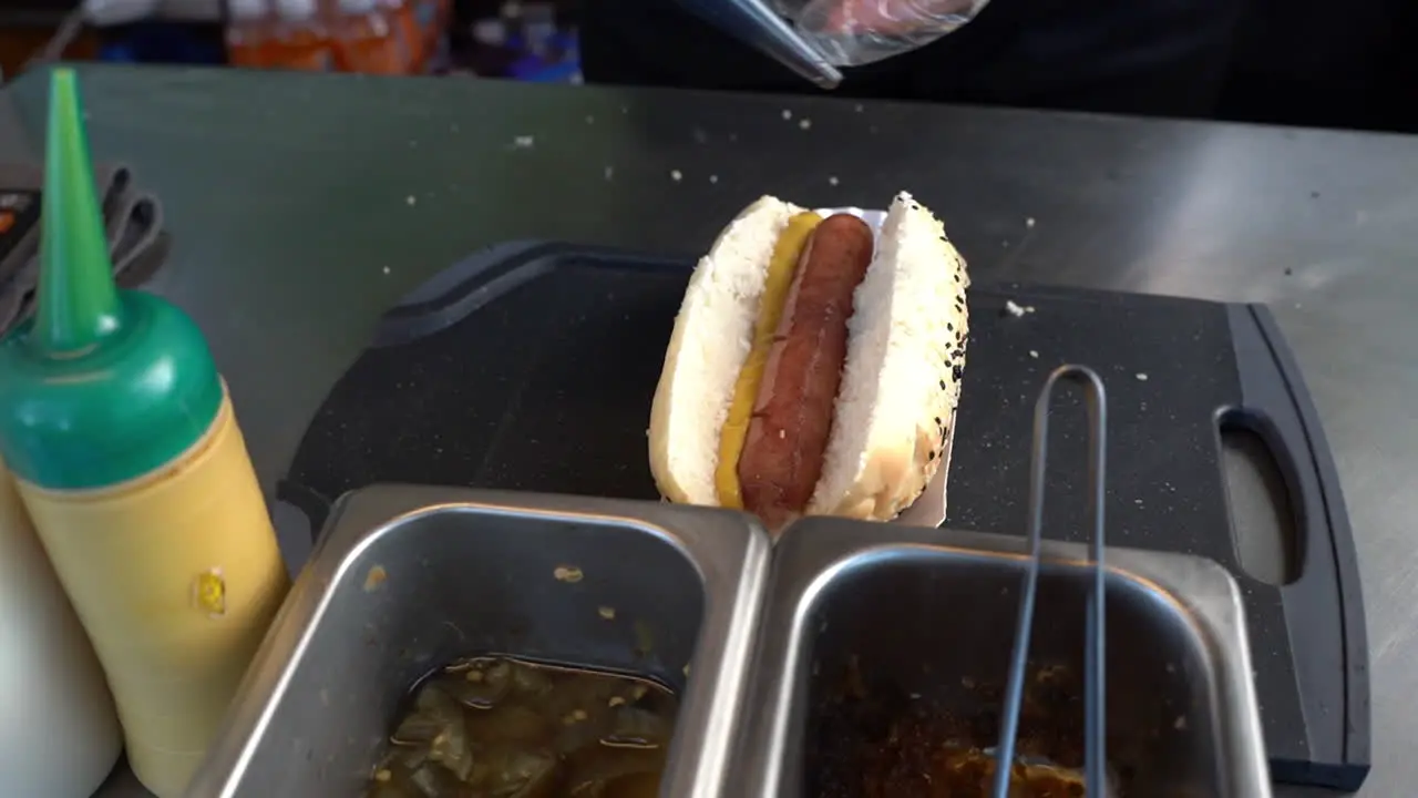 A Food Service Worker Prepared A Hot Dog Sandwich In A Fast Food Diner