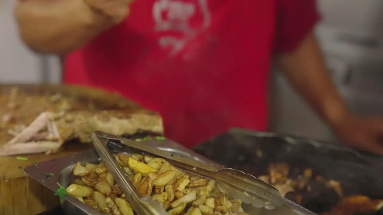 Chef prepare fast food with french fries in local truck close up