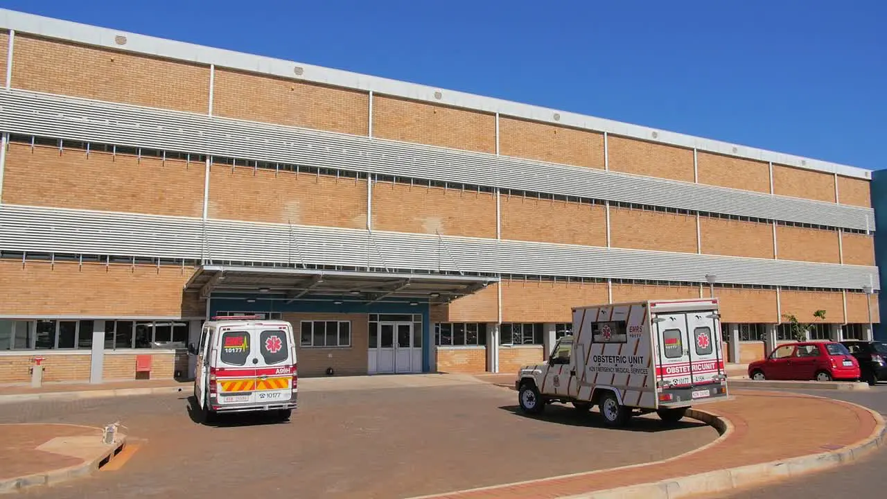 Ambulances parked outside of Lower Umfolozi Hospital KZN establishing shot