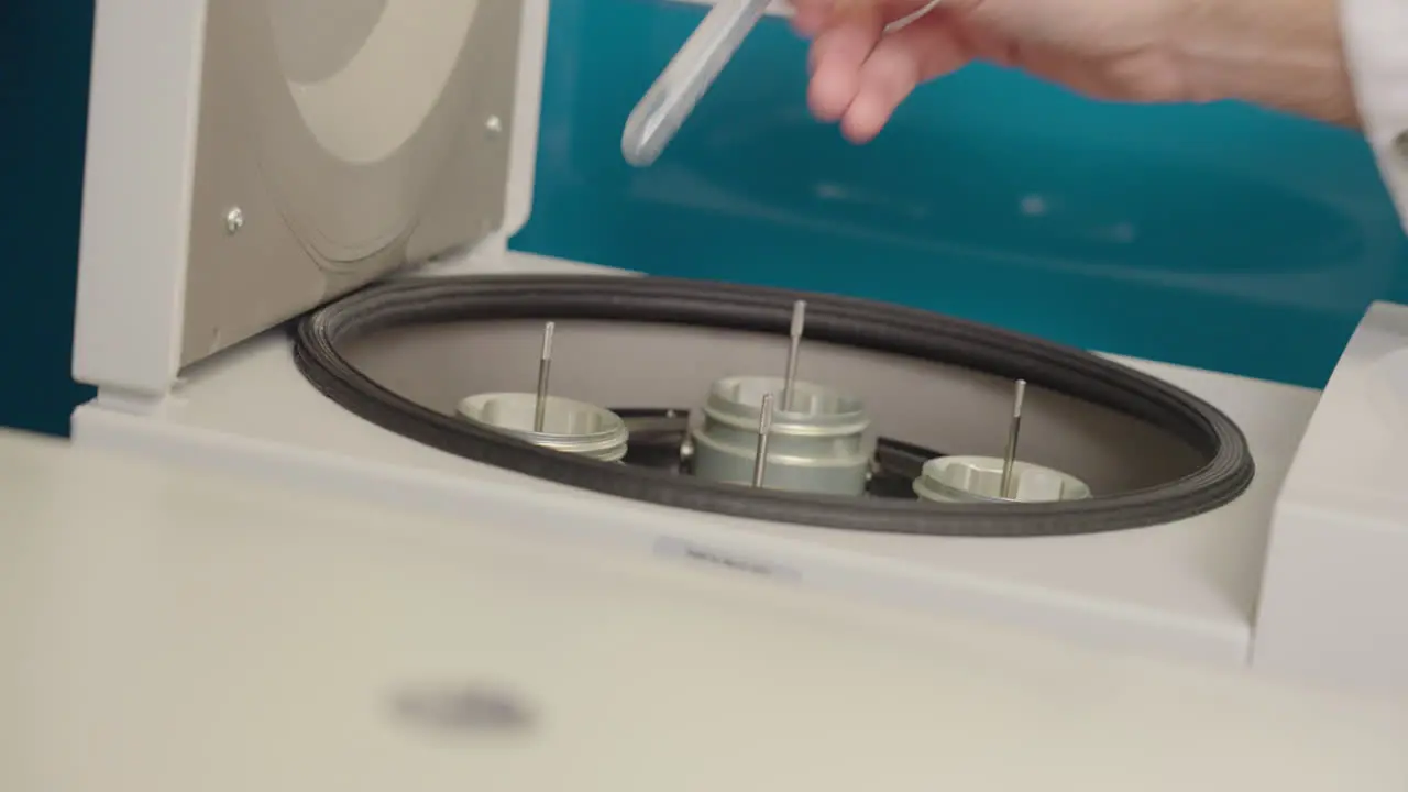 Close Up Of Scientist Putting Test Tube Research Samples Into Centrifuge Equipment In Science Laboratory 4K