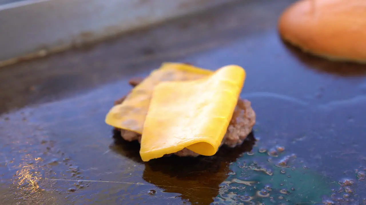 heating burger and cheese on grill