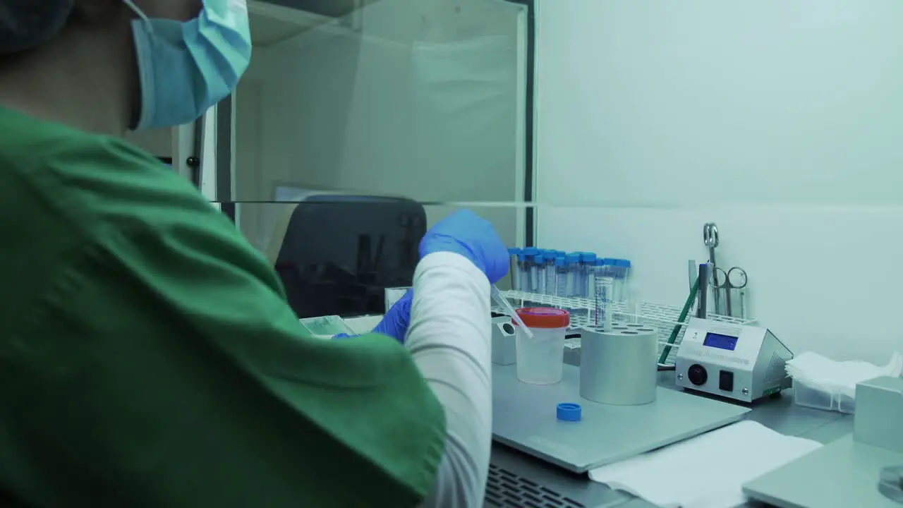 Over the shoulder nurse uses a pipette