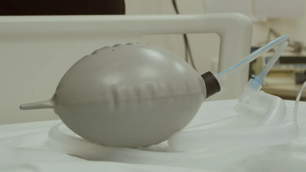 Breathing bag with valve inflates and deflates on hospital bed 