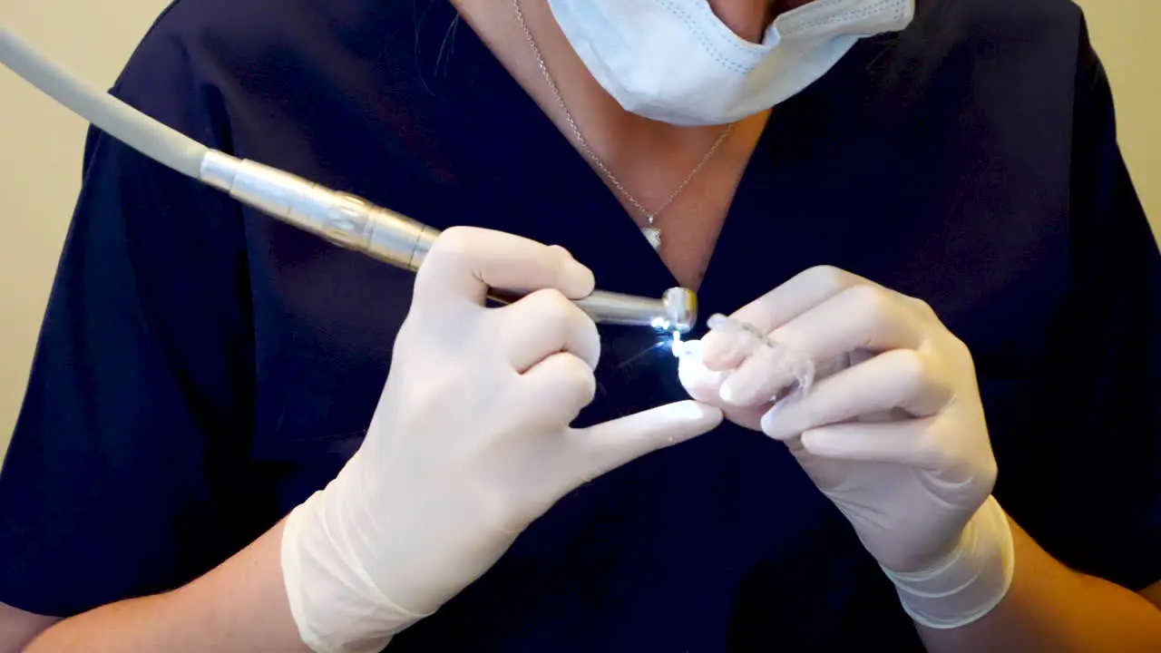 Medium shot in slowmotion of a dentist checking an invisalign retainer