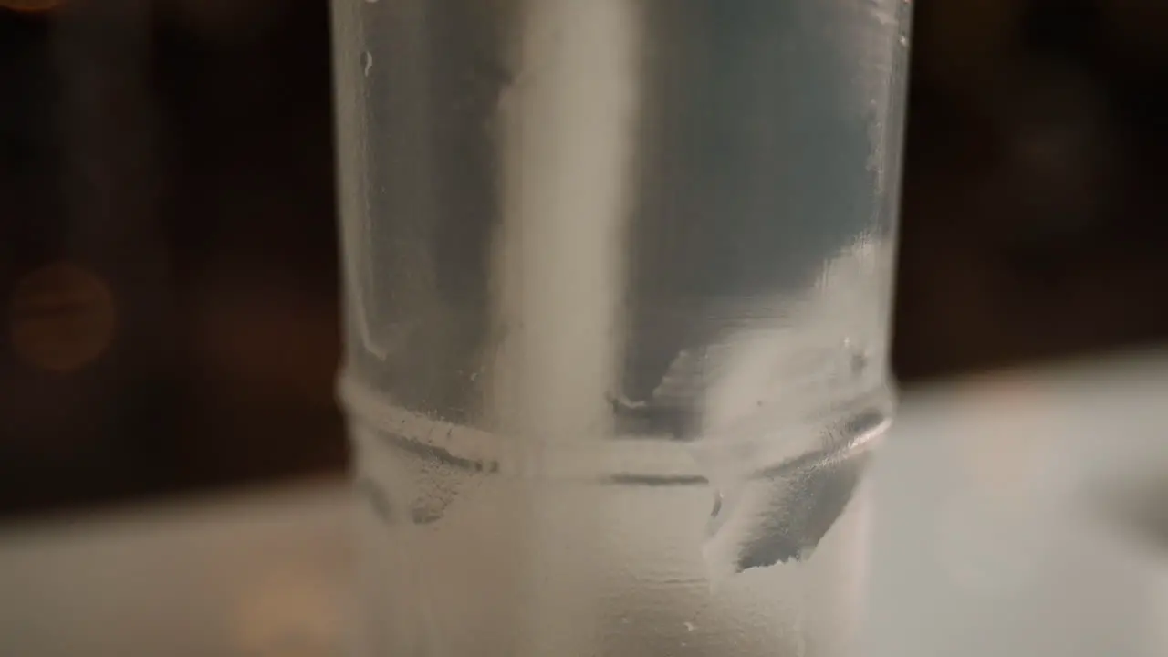 Close-up swirling a COVID-19 test swab in a tube for a rapid antigen test