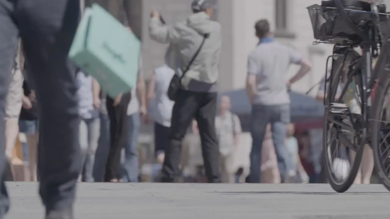 Full shot of people strolling the pedestrian zone on a summer day captured with a steady camera subjects in focus