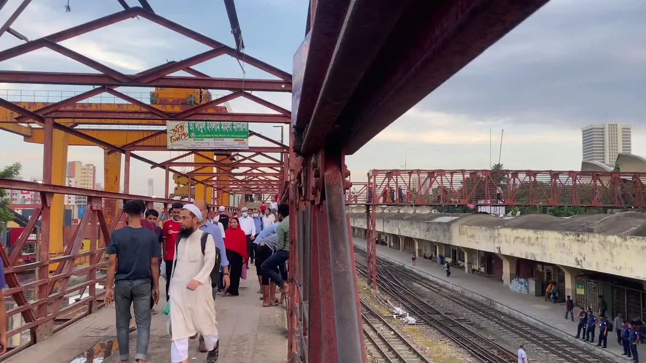 People walking at foot over bridge of Kamalapur railway station Dhaka Static shot