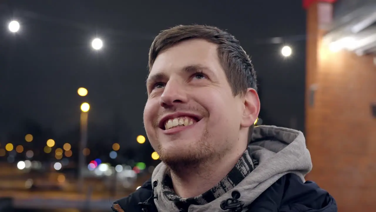 Confident and smiling young caucasian male in closeup enjoys life